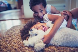 A fluffy white dog playing with its kids